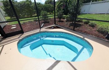 Pool cleaning and maintenance equipment on the edge of a swimming pool deck.